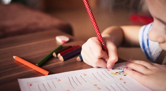 child holding pencil printing
