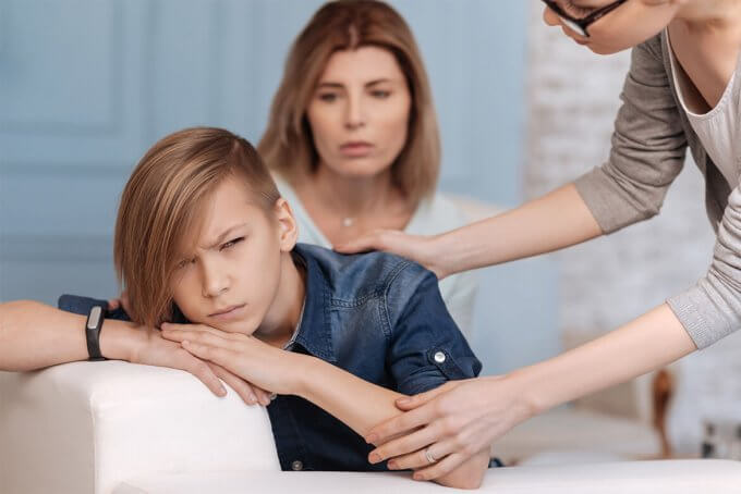 Caucasian family trying to reach their depressed teen.