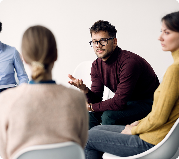 young-man-communicating-with-participants-group-therapy-community-center