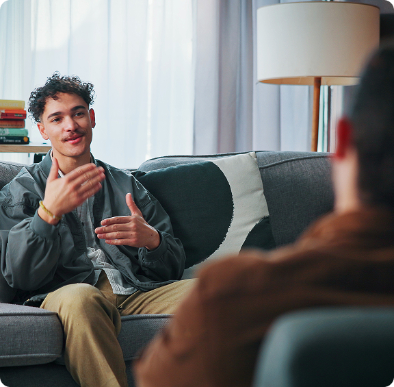 young-man-communicating-with-participants-group-therapy-community-center CBT Therapy